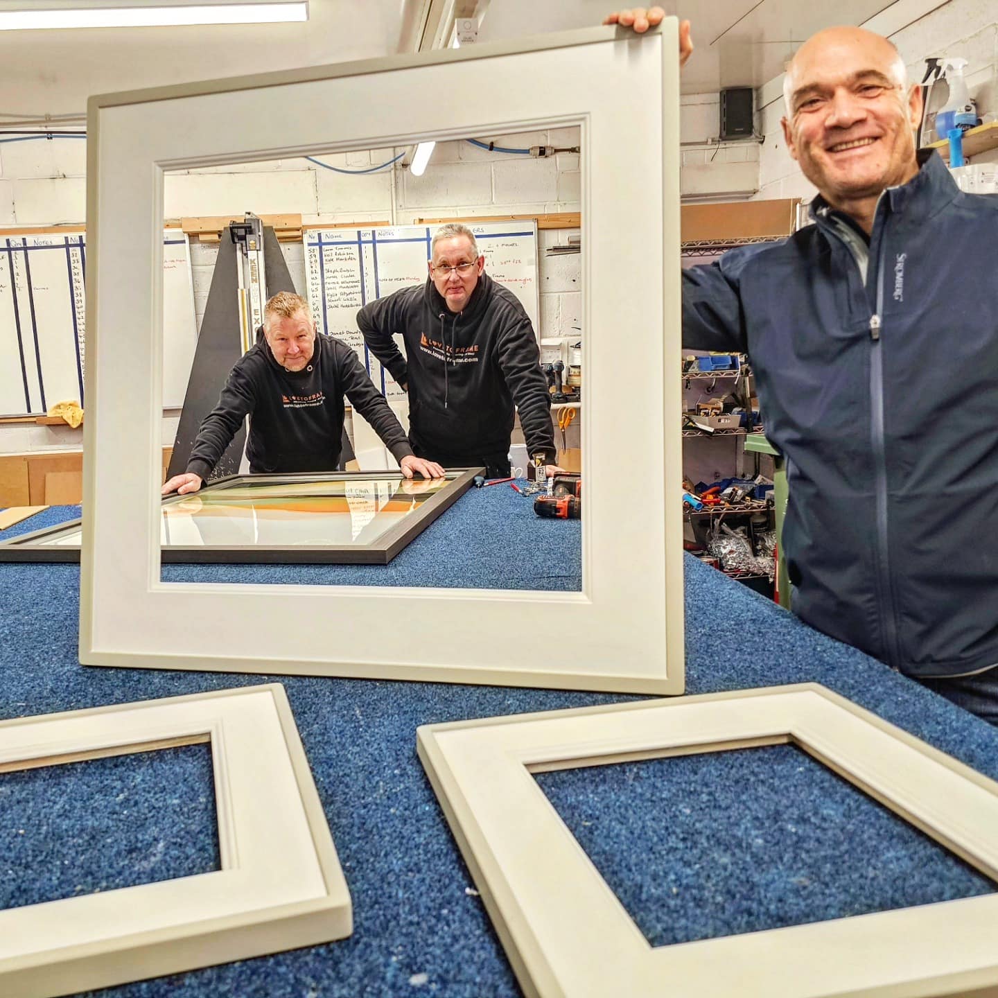 The Love to Frame team checking a hand-finished frame and wide conservation mount in the Timperley workshop, South Manchester